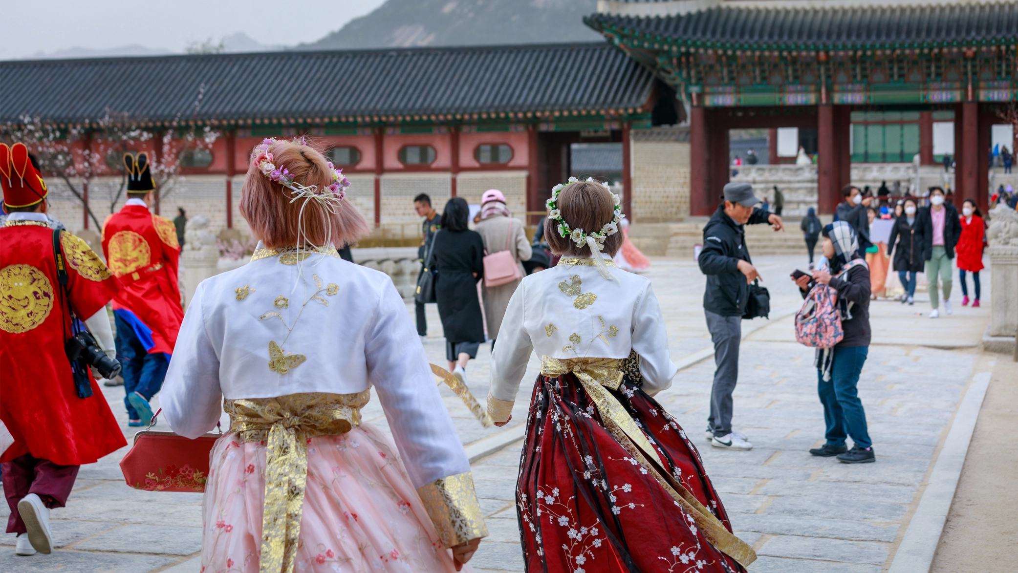 Asian Korean woman dressed Hanbok in traditional dress walking in Gyeongbokgung Palace