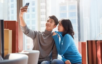 happy-young-asian-couple-taking-selfie happy-young-asian-couple-taking-selfie