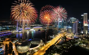 Fireworks over Marina Bay in Singapore during a festival, perfect for travellers staying at a hotel near MRT Singapore.