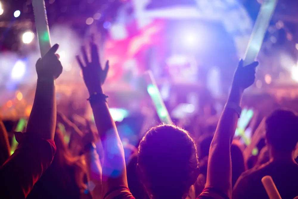 F1 Singapore Grand Prix after-race concert with fans enjoying live music, lights, and nightlife near hotel deals.