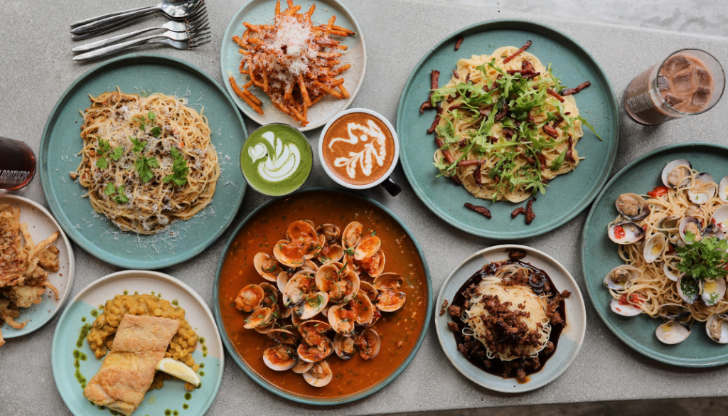  Variety of pasta dishes, seafood, and artisanal coffee served at a stylish café near a KL hotel near KLCC, offering unique dining experiences in Kuala Lumpur.