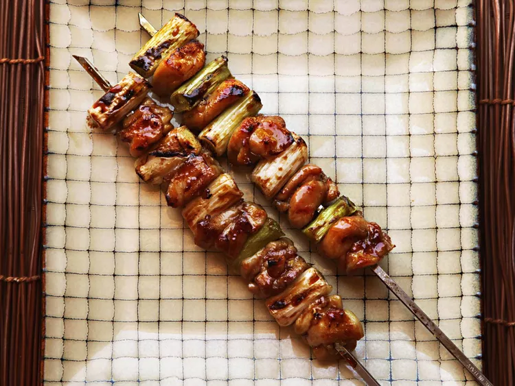 Grilled yakitori skewers served at Nishiki Market in Kyoto, a must-try Japanese street food near many central Kyoto hotels.