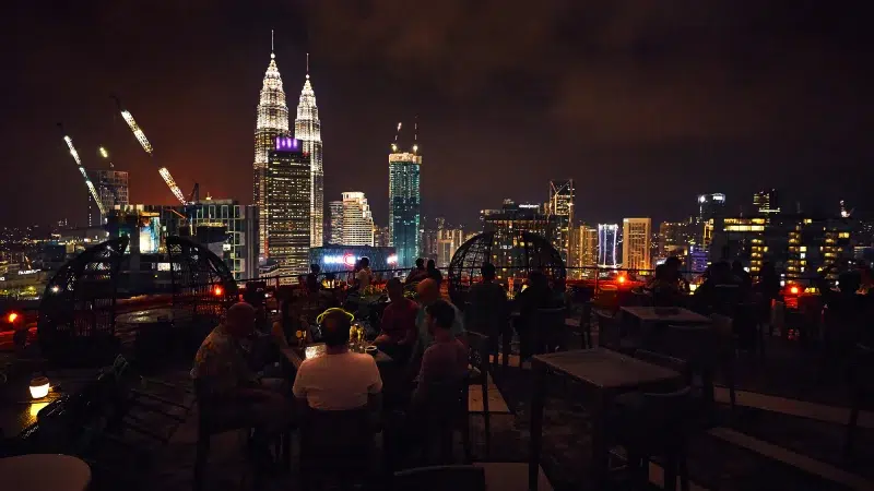 A rooftop bar view of the Petronas Towers