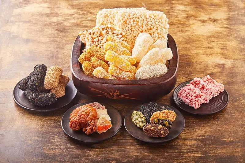 Varied colors and shapes of hangwa in plates, presented on a table