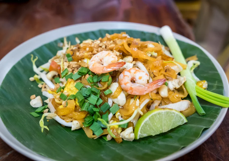 Pad Thai street food prepared on a plate with a banana leaf