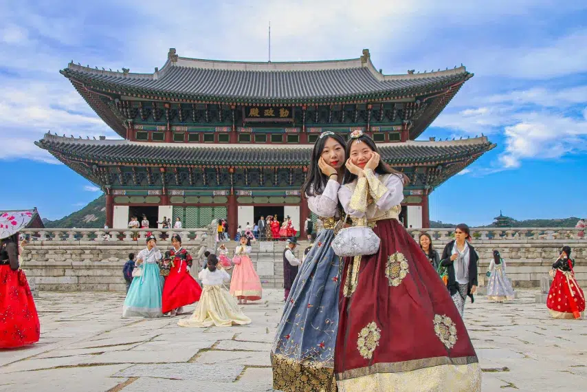 Young Asian women dressed in traditional Korean hanbok at Gwanghwamun Square