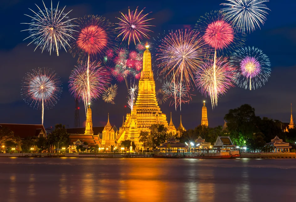 Fireworks over the horizon of the Chao Phraya River ring in the new year