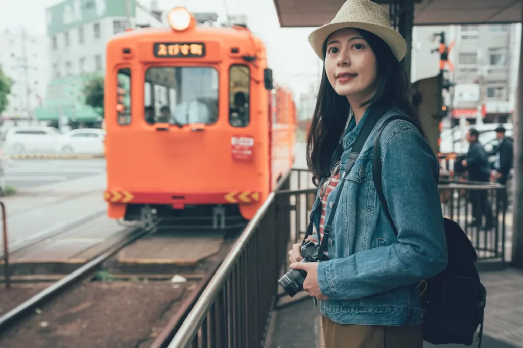 a woman happilyb smiling at the train station